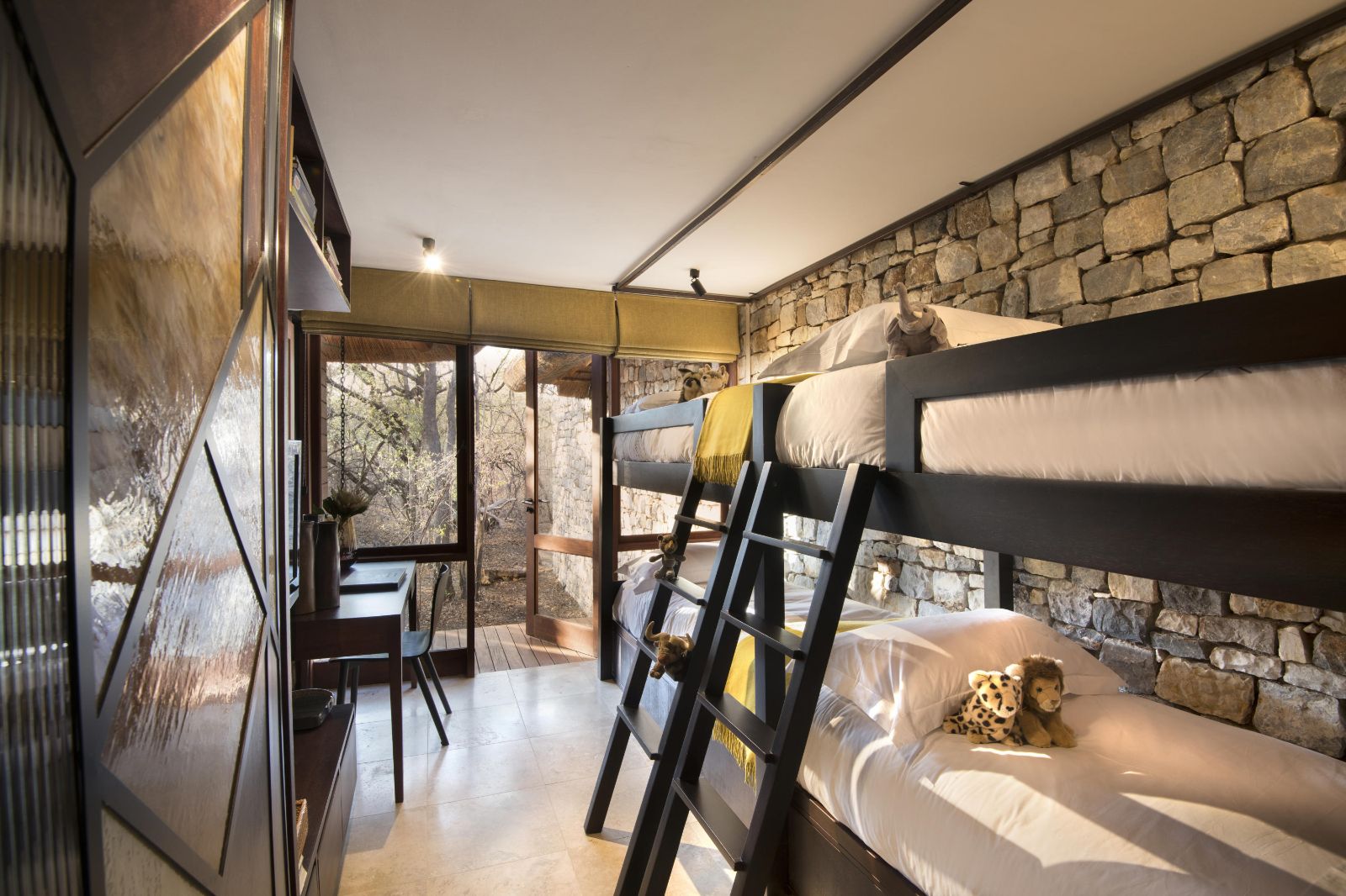 Children's bunk room with stuffed African animals at luxury private house Morukuru River House in the Madikwe Game Reserve in South Africa