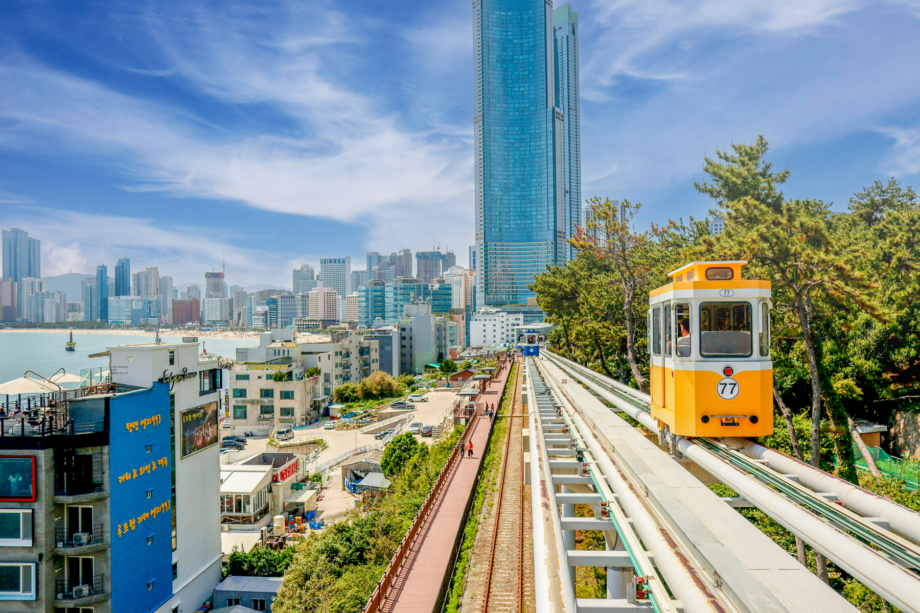 A yellow sky capsule above Busan