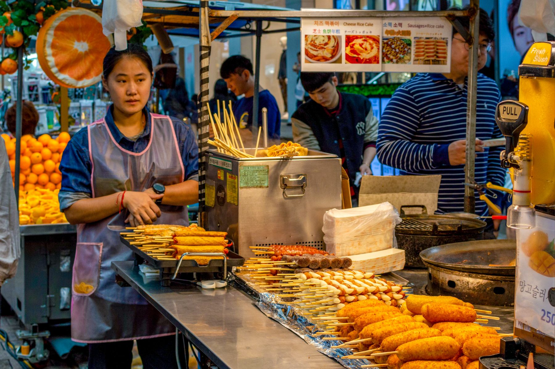 A woman serving traditional Korean street food in Myeongdong