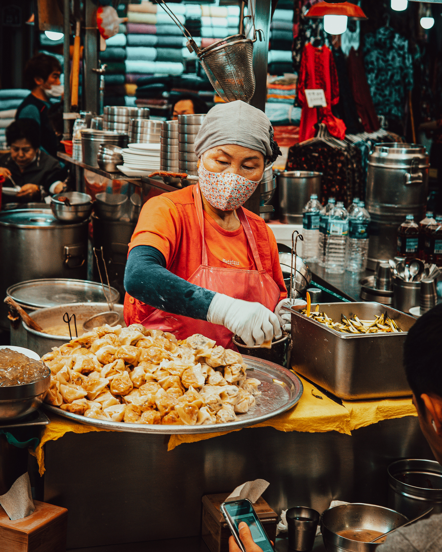 A Korean woman preparing food at Gwangjang Market in Seoul