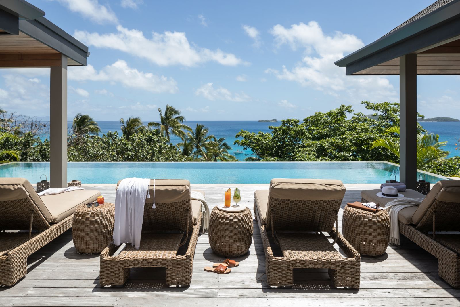 Loungers by the private pool of a Sunset Residence overlooking the Pacific Ocean at luxury resort Kokomo Island in Fiji