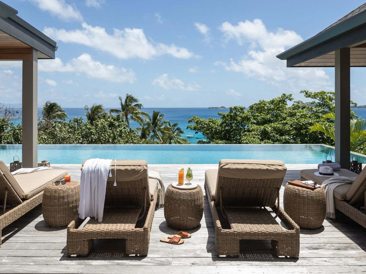 Loungers by the private pool of a Sunset Residence overlooking the Pacific Ocean at luxury resort Kokomo Island in Fiji