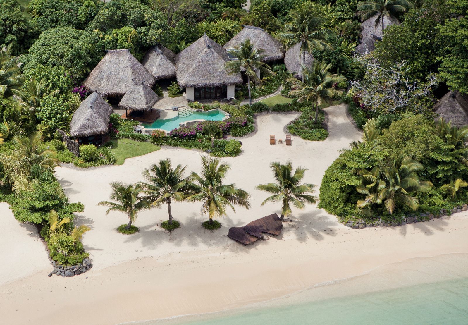 Aerial view of a beachfront plantation villa at COMO Laucala Fiji
