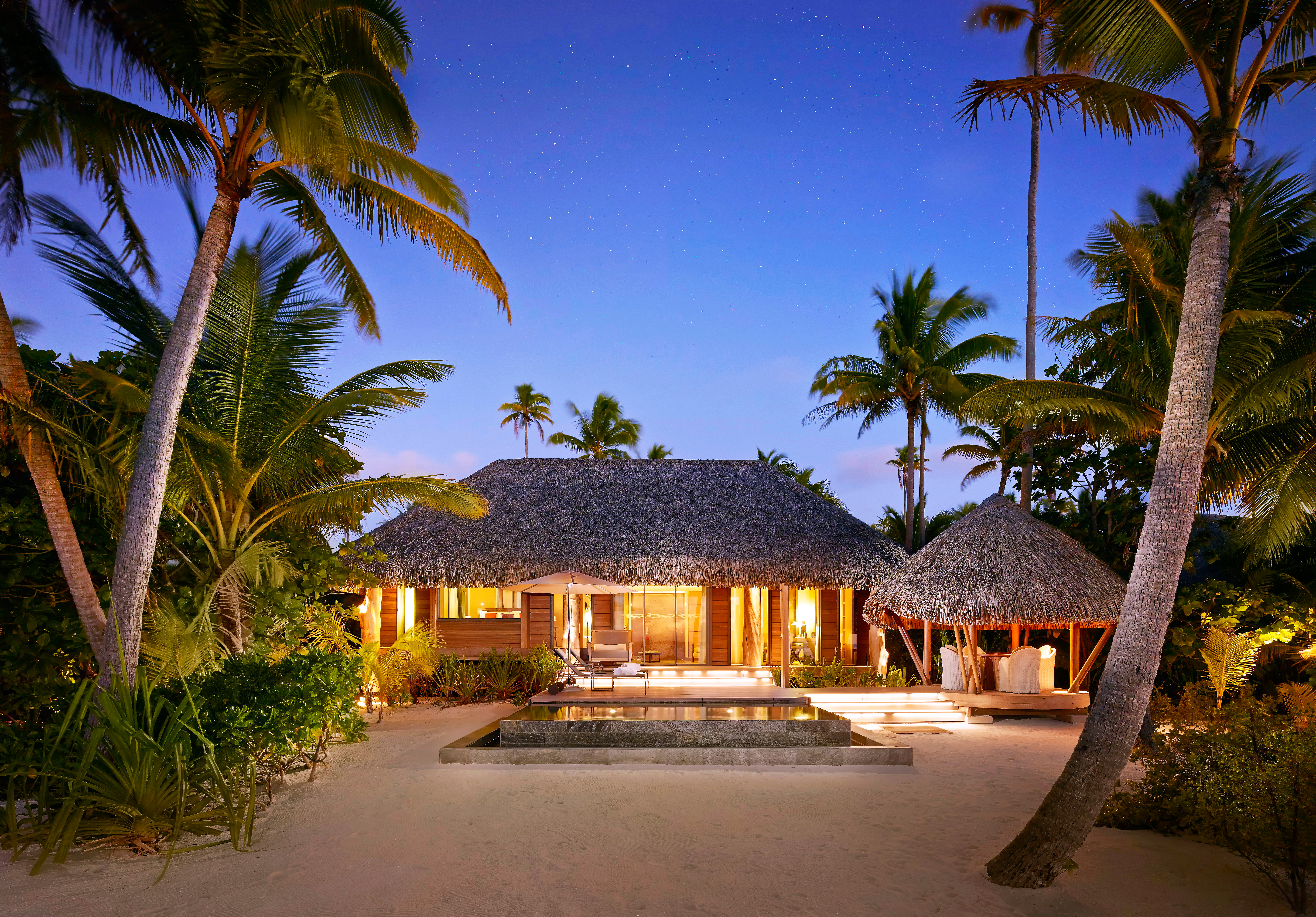 A villa at twilight at the Brando in French Polynesia