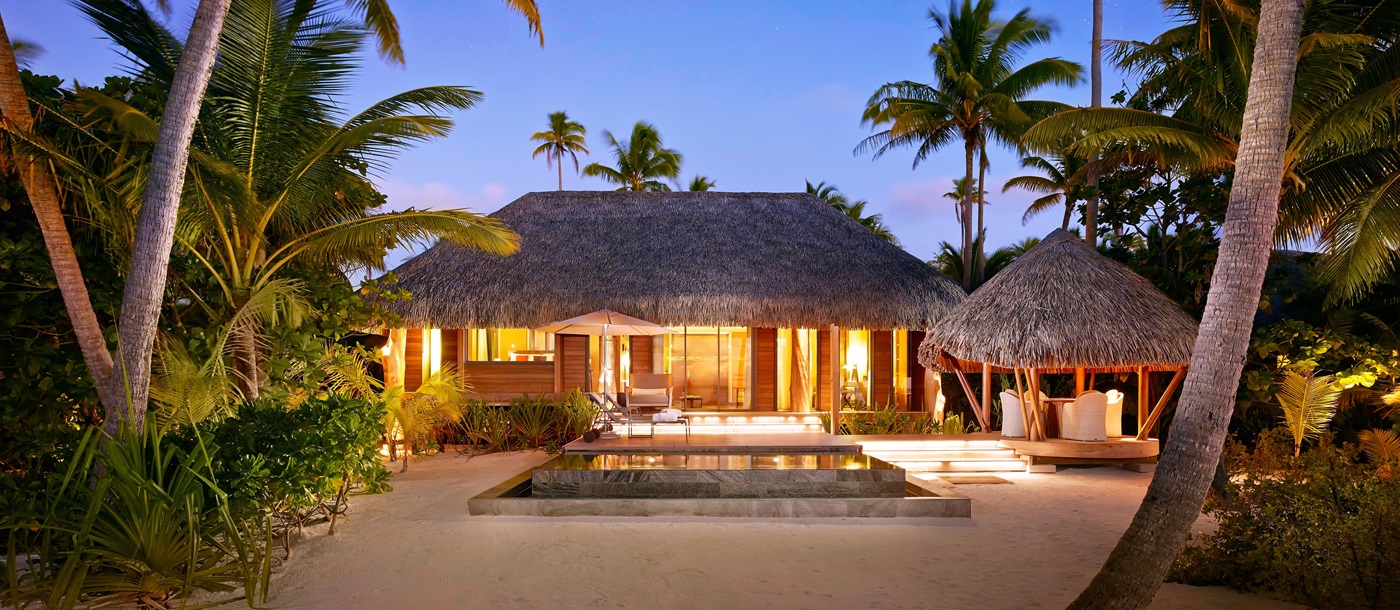 A villa at twilight at the Brando in French Polynesia