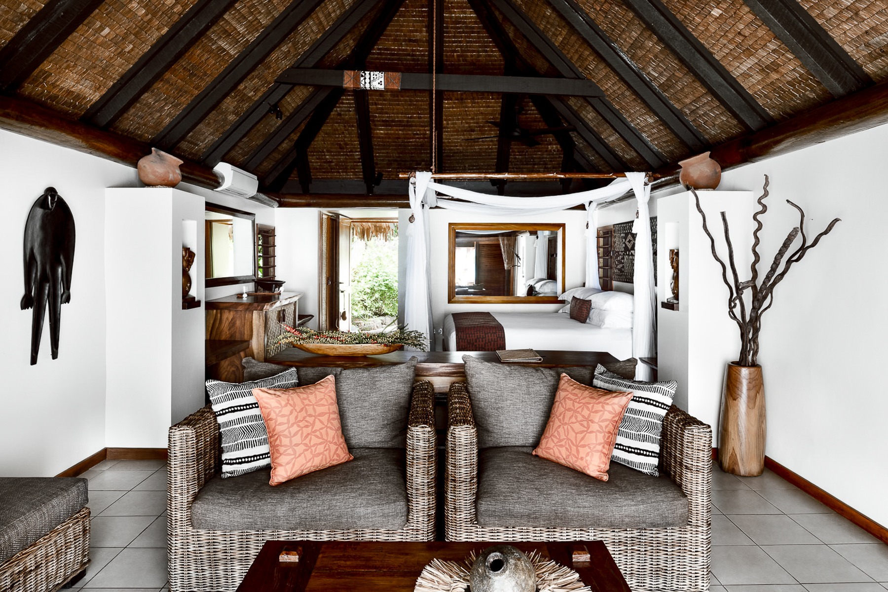 Lounge and bedroom inside a bure at Tokoriki Island Resort in Fiji