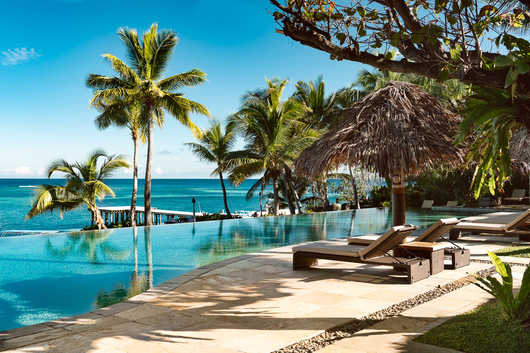 Loungers by the infinity pool at Tokoriki Island Resort in Fiji