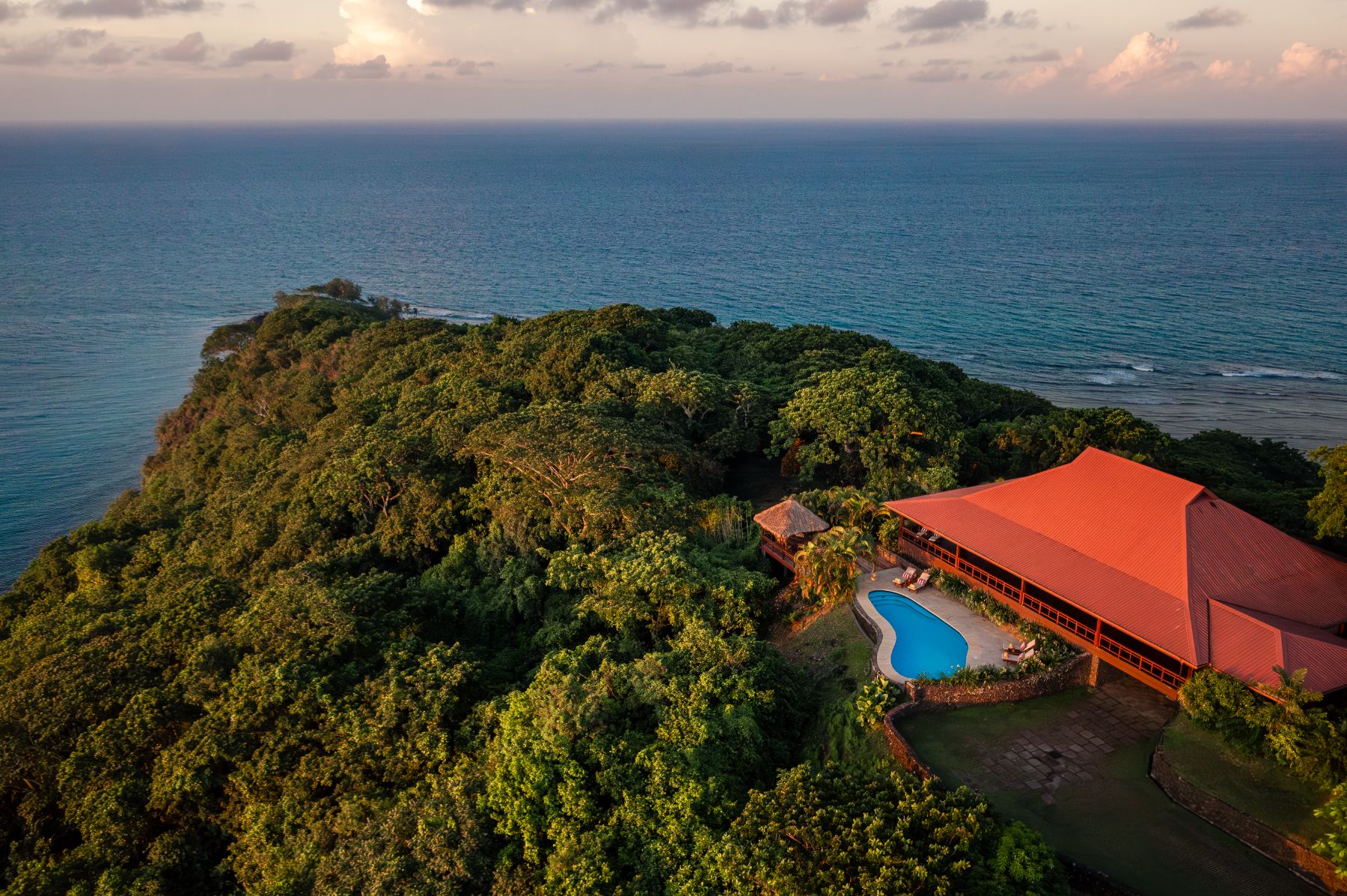 Aerial view of a cliffside bure at Wakaya Island Resort in Fiji