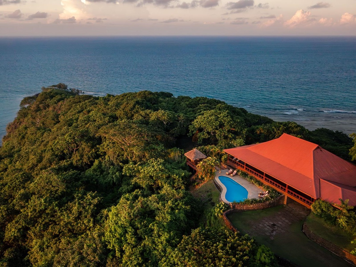 Aerial view of a cliffside bure at Wakaya Island Resort in Fiji