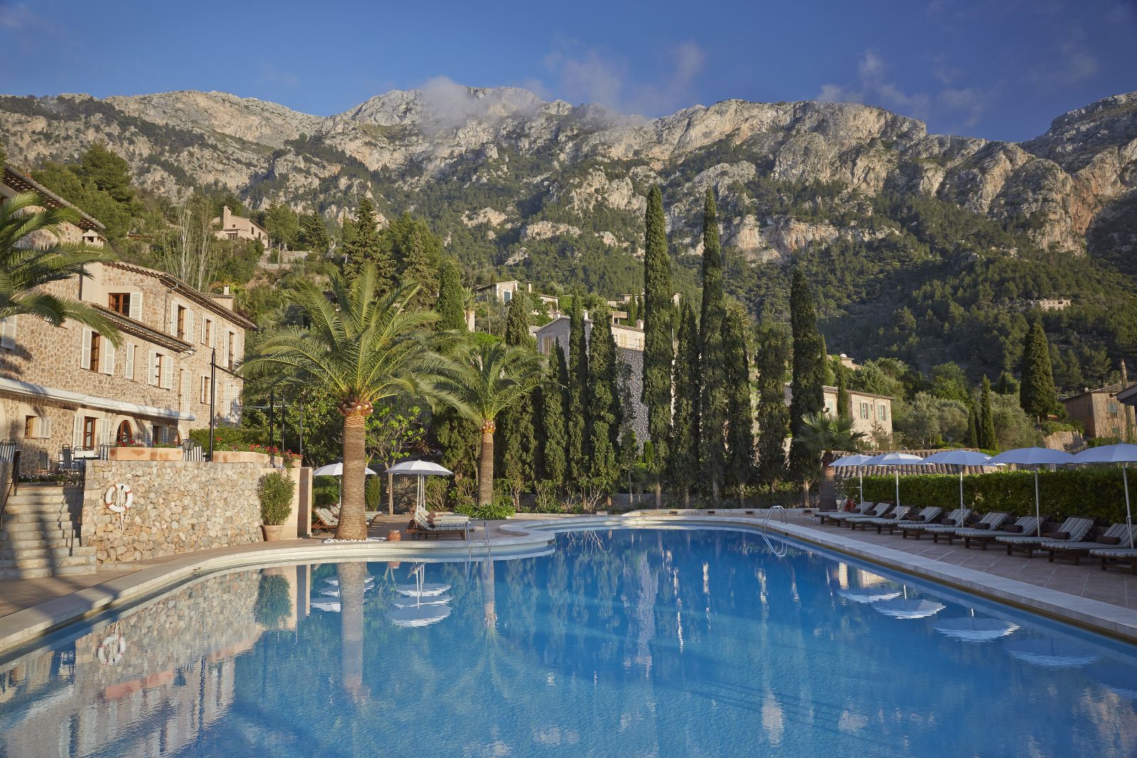 Swimming pool with mountain backdrop at Belmond La Residencia hotel in Mallorca