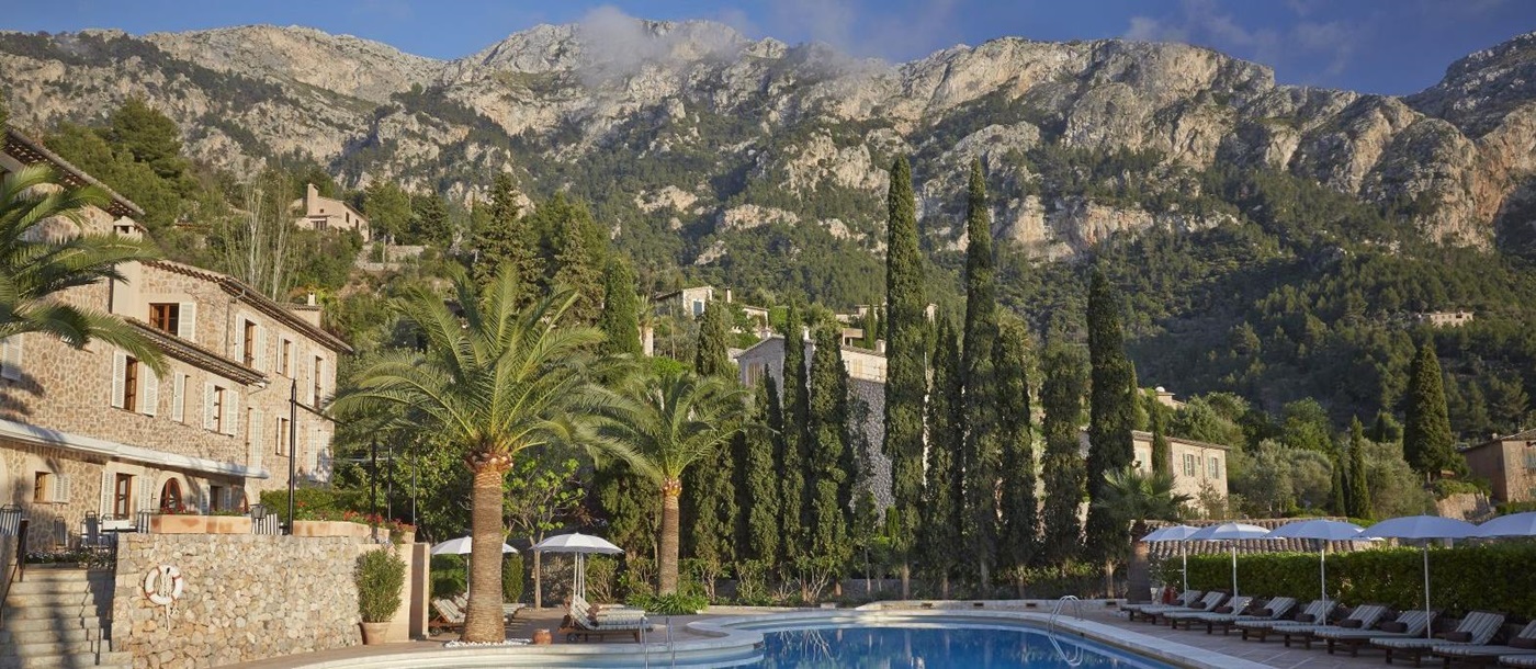 Swimming pool with mountain backdrop at Belmond La Residencia hotel in Mallorca