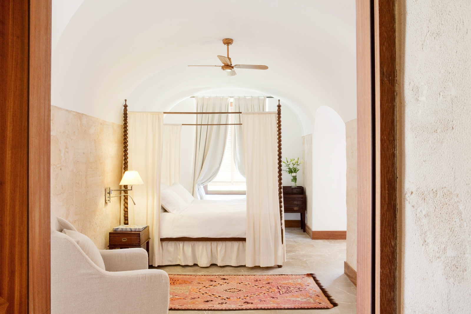 Interior of an El Cabo suite with white furniture and dark wooden accents