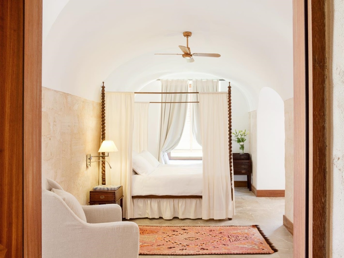 Interior of an El Cabo suite with white furniture and dark wooden accents