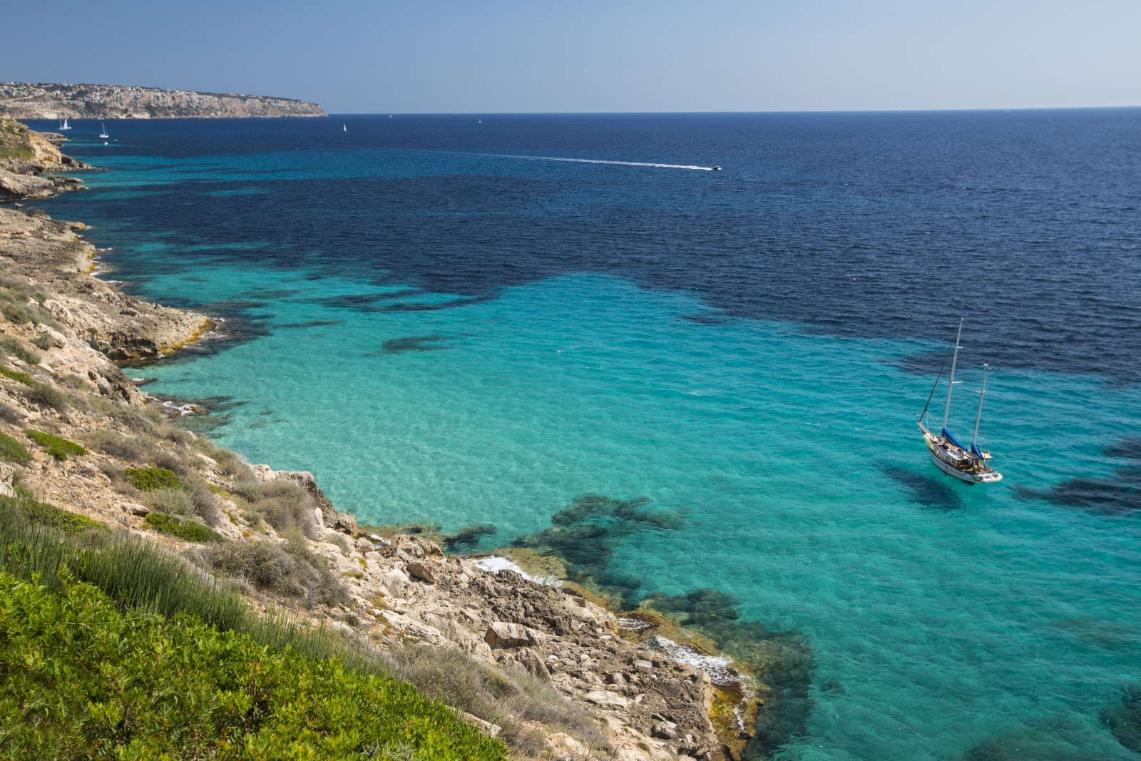 A boat on the turquoise waters of the Mediterranean Sea