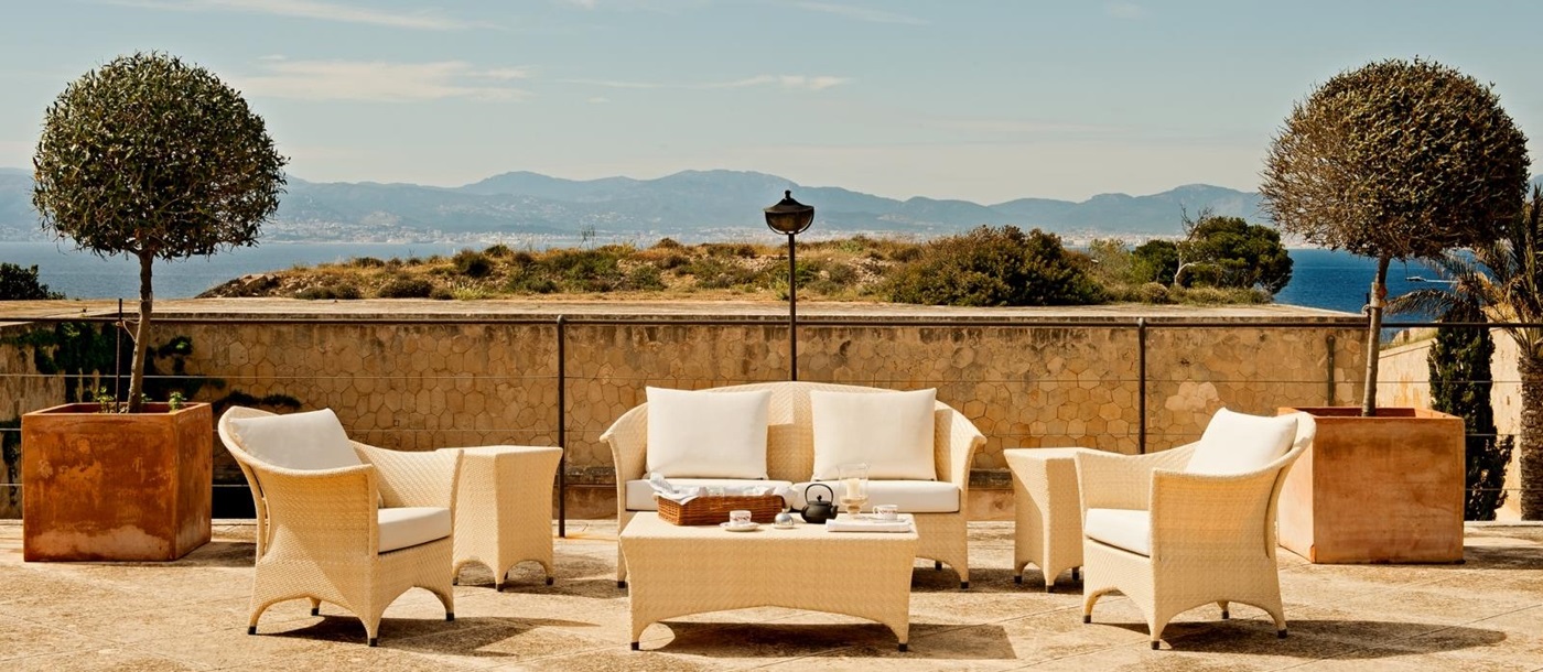 Terrace seating with views across the bay at luxury resort Cap Rocat on Mallorca, Spain