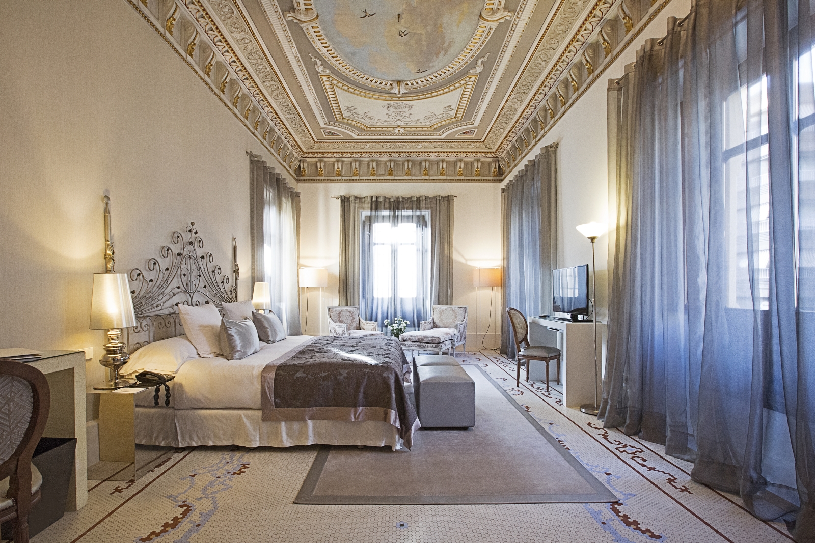 Large presidential suite with ornate ceilings at Hospes Palacio de Los Patos in Spain