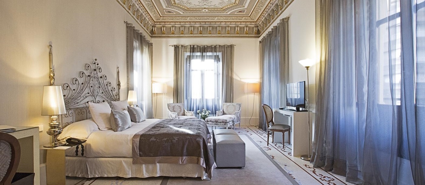 Large presidential suite with ornate ceilings at Hospes Palacio de Los Patos in Spain