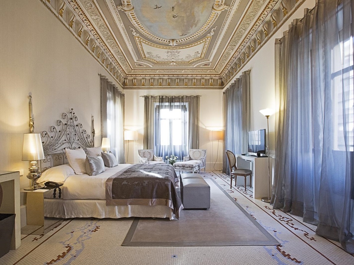 Large presidential suite with ornate ceilings at Hospes Palacio de Los Patos in Spain