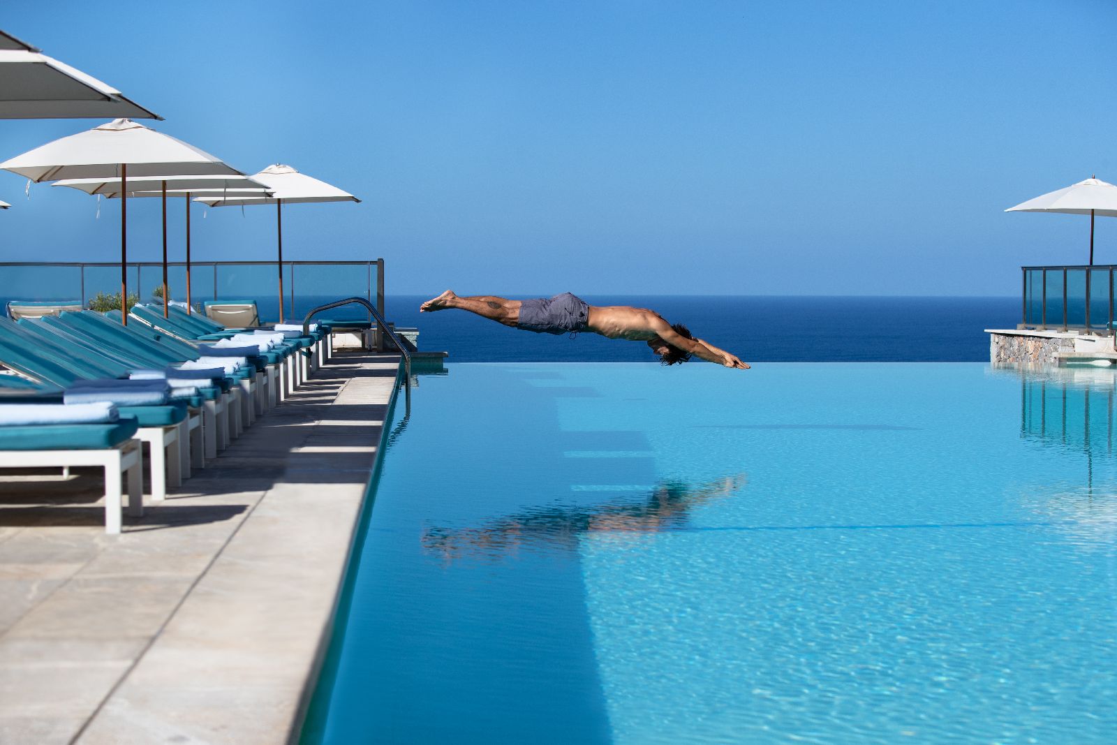 Guest diving in to the infinity pool at the Jumeirah Port Soller hotel in Mallorca