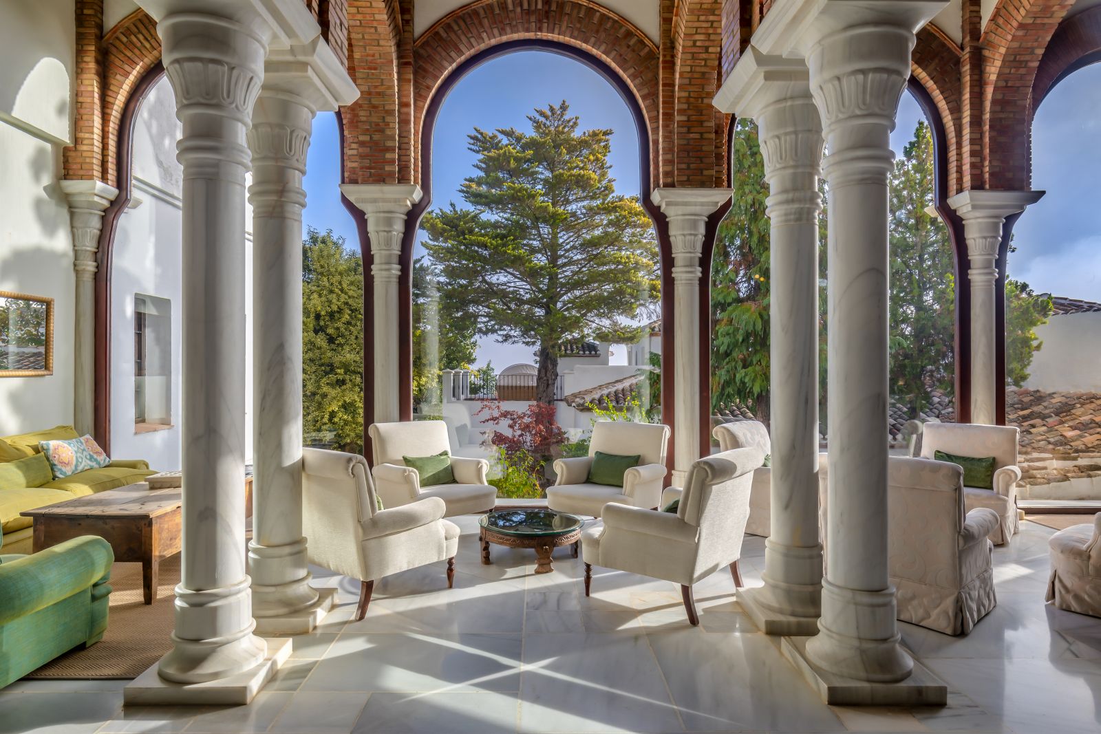 Foyer with columns and archways into the gardens at luxury resort La Bobadilla near Grenada, Spain