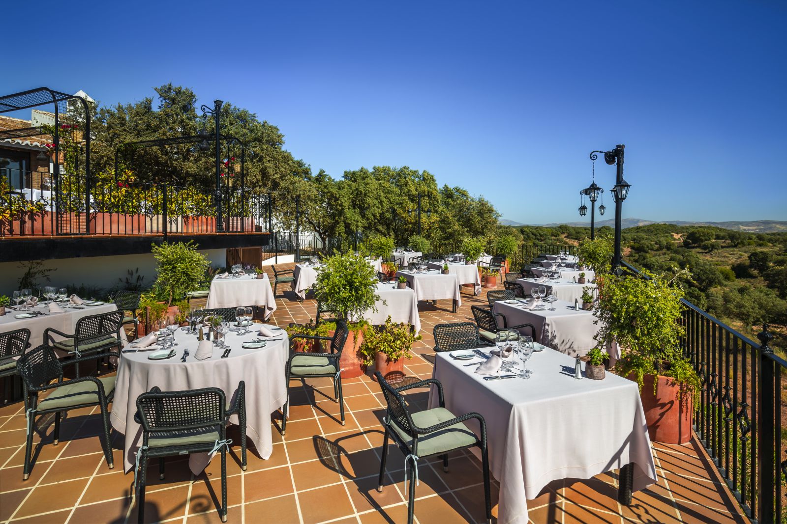 Al fresco dining on the terrace of luxury resort La Bobadilla near Grenada, Spain overlooking the surrounding landscape