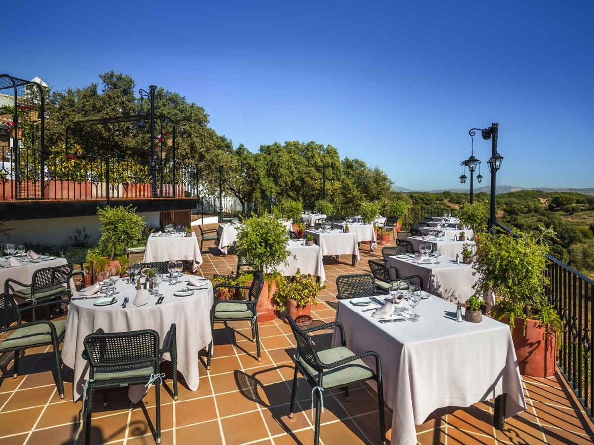 Al fresco dining on the terrace of luxury resort La Bobadilla near Grenada, Spain overlooking the surrounding landscape