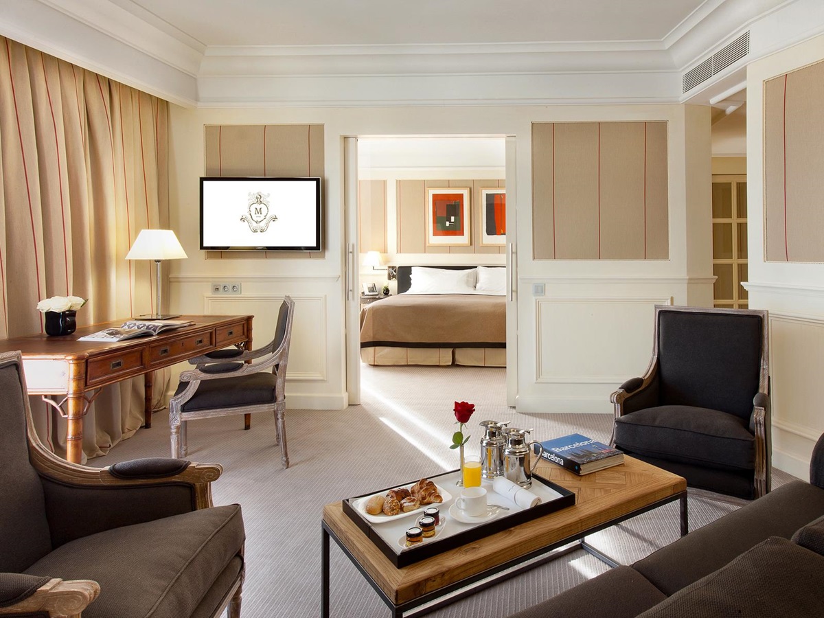 Bedroom and living area inside a guest suite at the Majestic Hotel & Spa in Barcelona