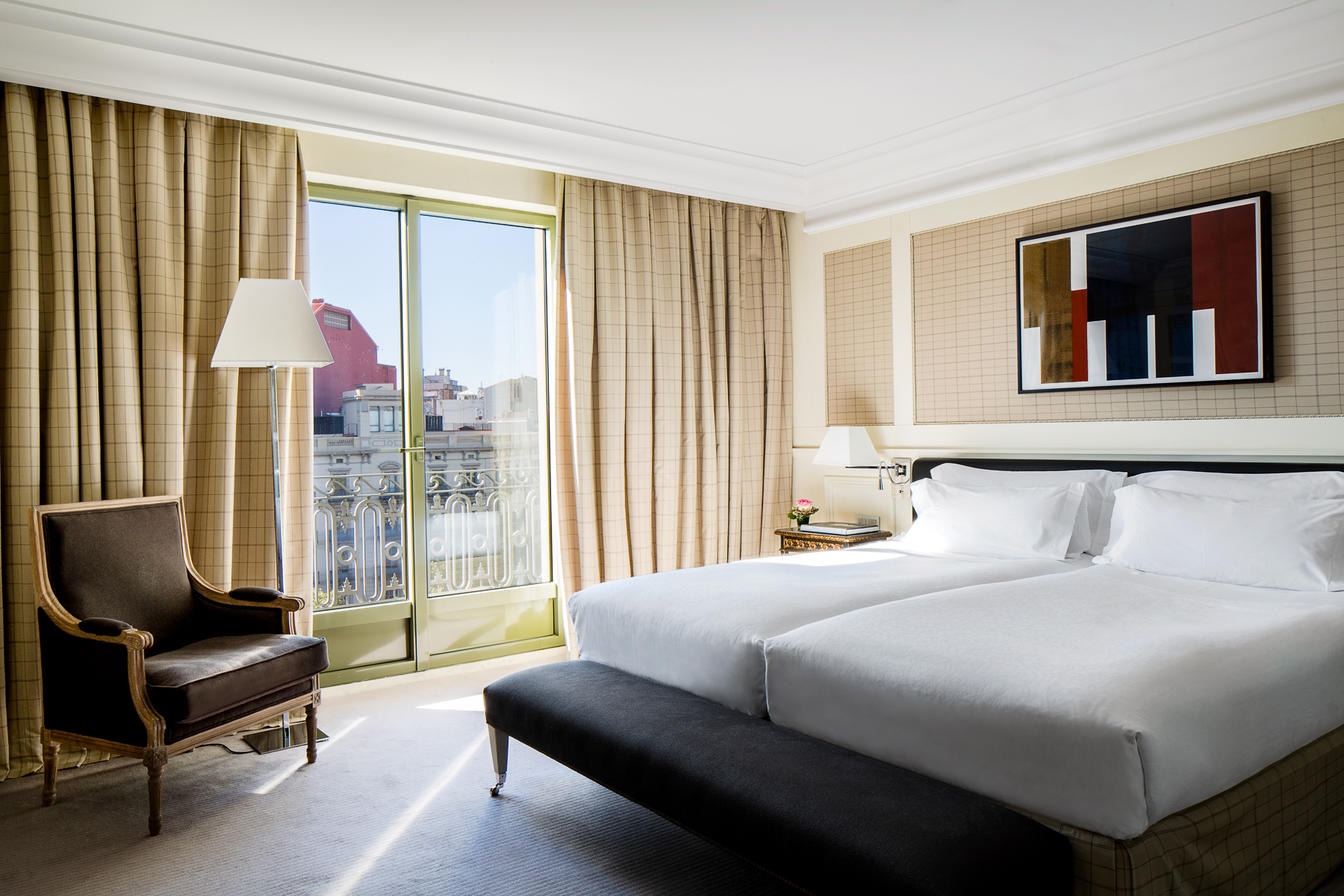 Guest bedroom with city views at the Majestic Hotel & Spa in Barcelona