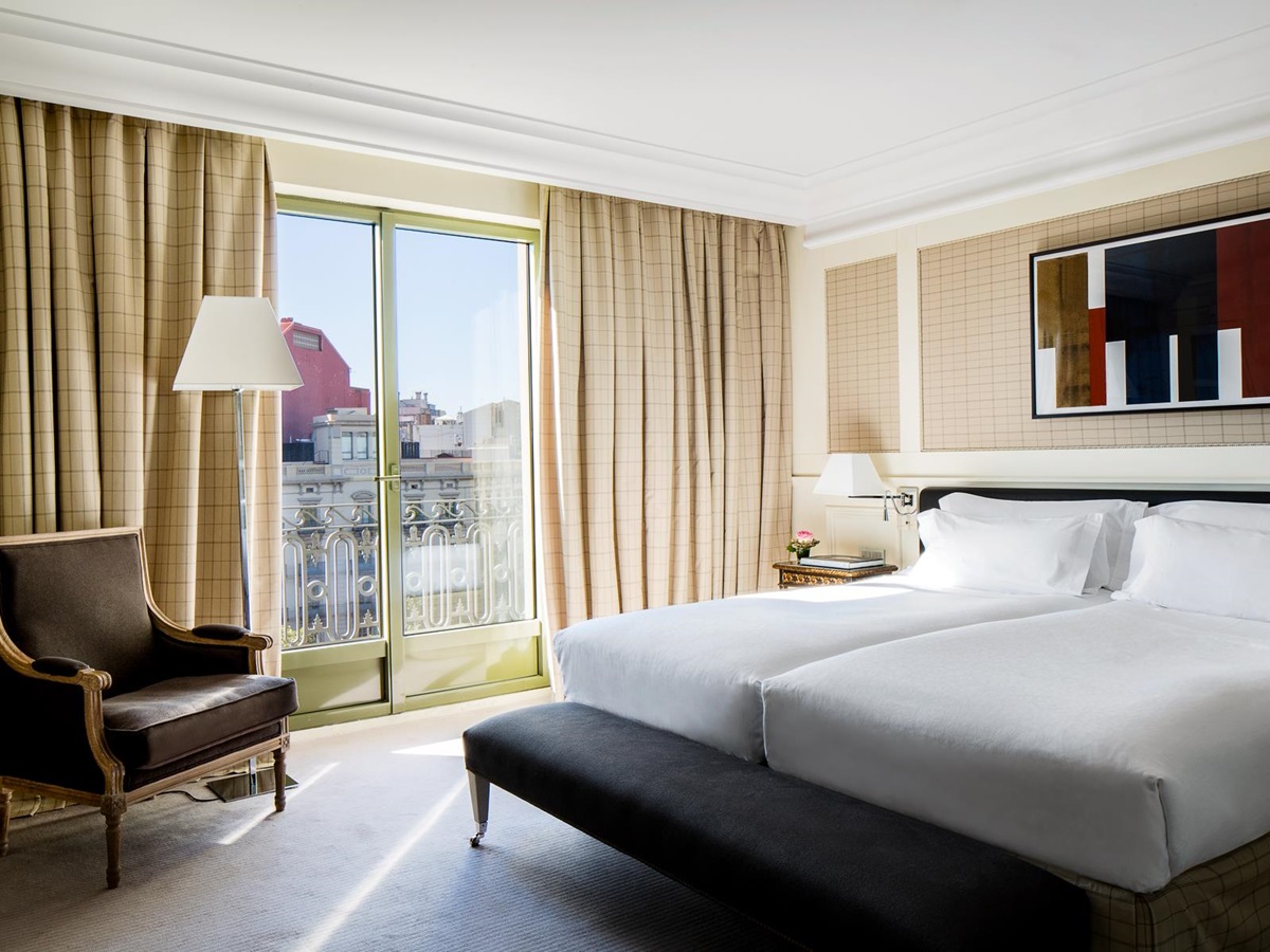 Guest bedroom with city views at the Majestic Hotel & Spa in Barcelona