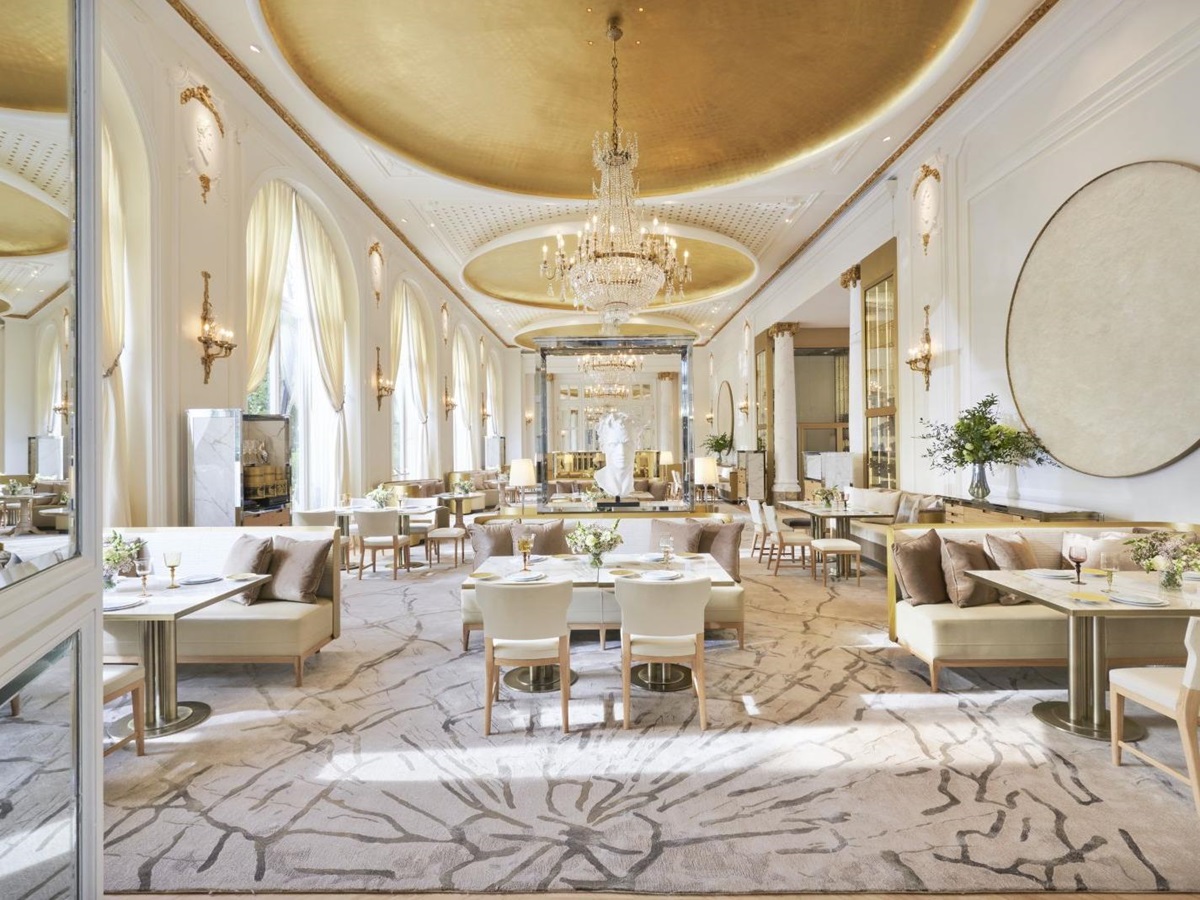 Dining area of Deessa Restaurant at luxury hotel Mandarin Oriental Ritz Madrid with floor to ceiling windows and a grande chandelier