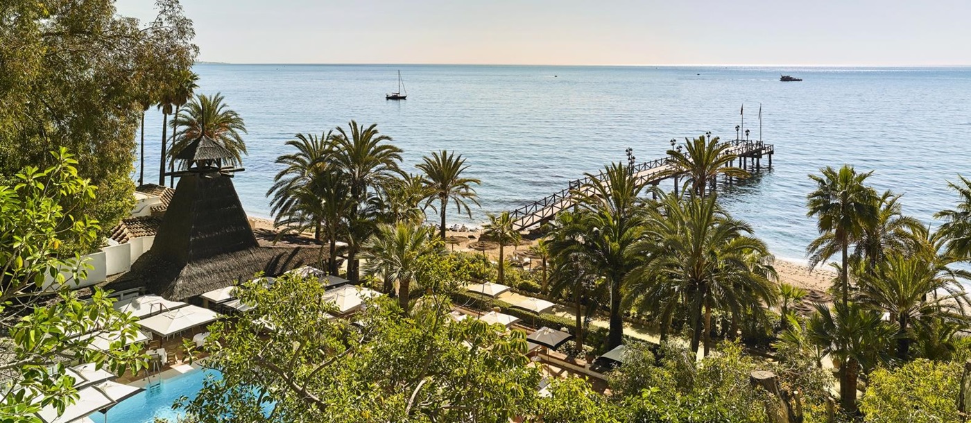 View over pool and garden to the sea at luxury resort Marbella Club in Spain