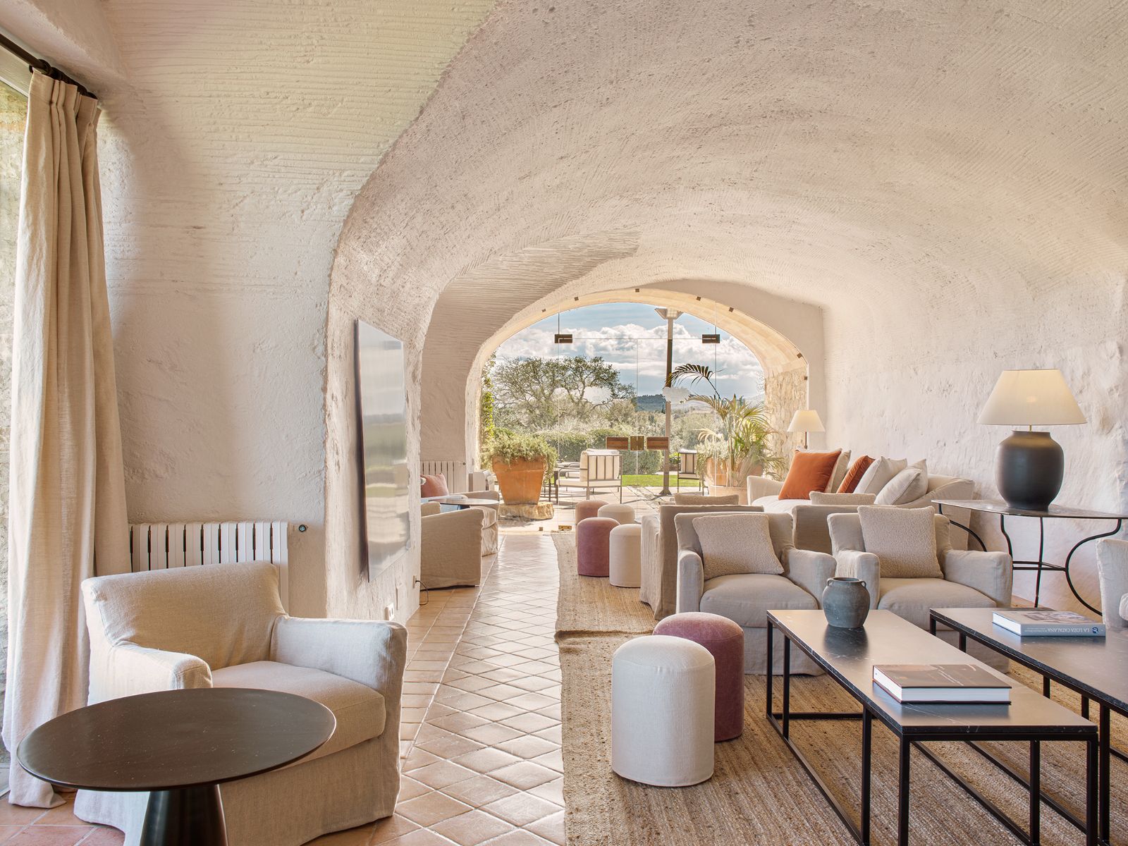 Lounge area at luxury hotel Mas de Torrent in Spain with large window overlooking the lush countryside