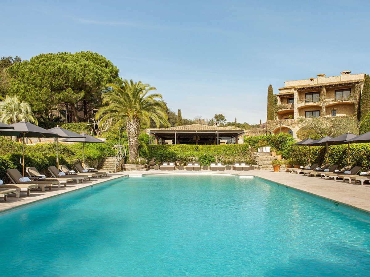 Communal pool with loungers at luxury hotel Mas de Torrent in Spain
