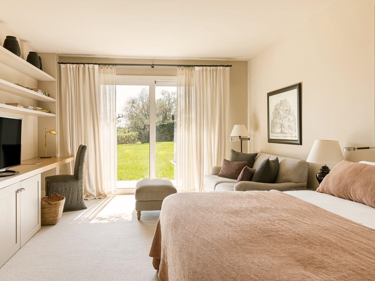 Light and airy bedroom with garden access at luxury hotel Mas de Torrent in Spain