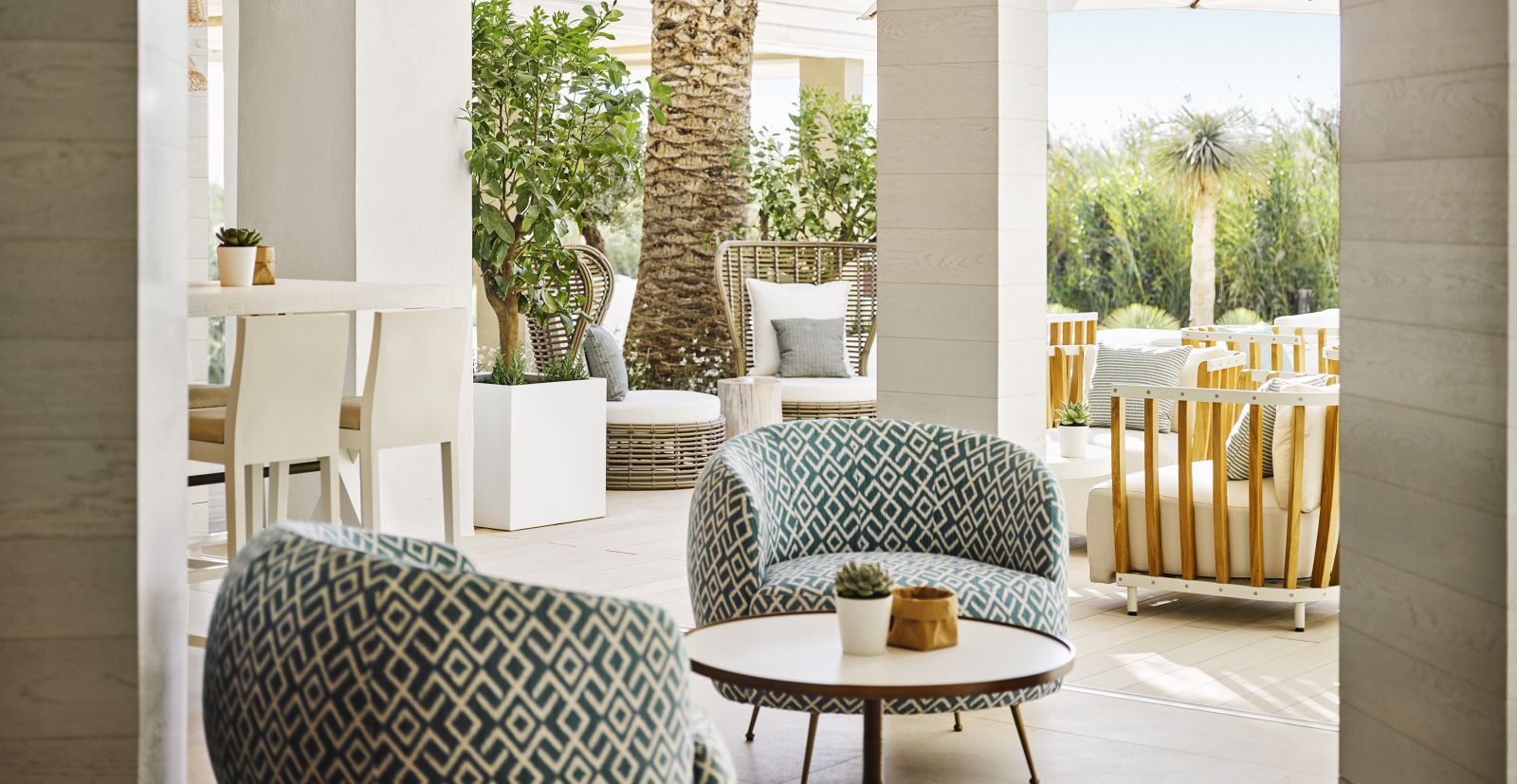 Variety of comfortable seating options on the terrace of Bay Cafe at luxury hotel Nobu Ibiza