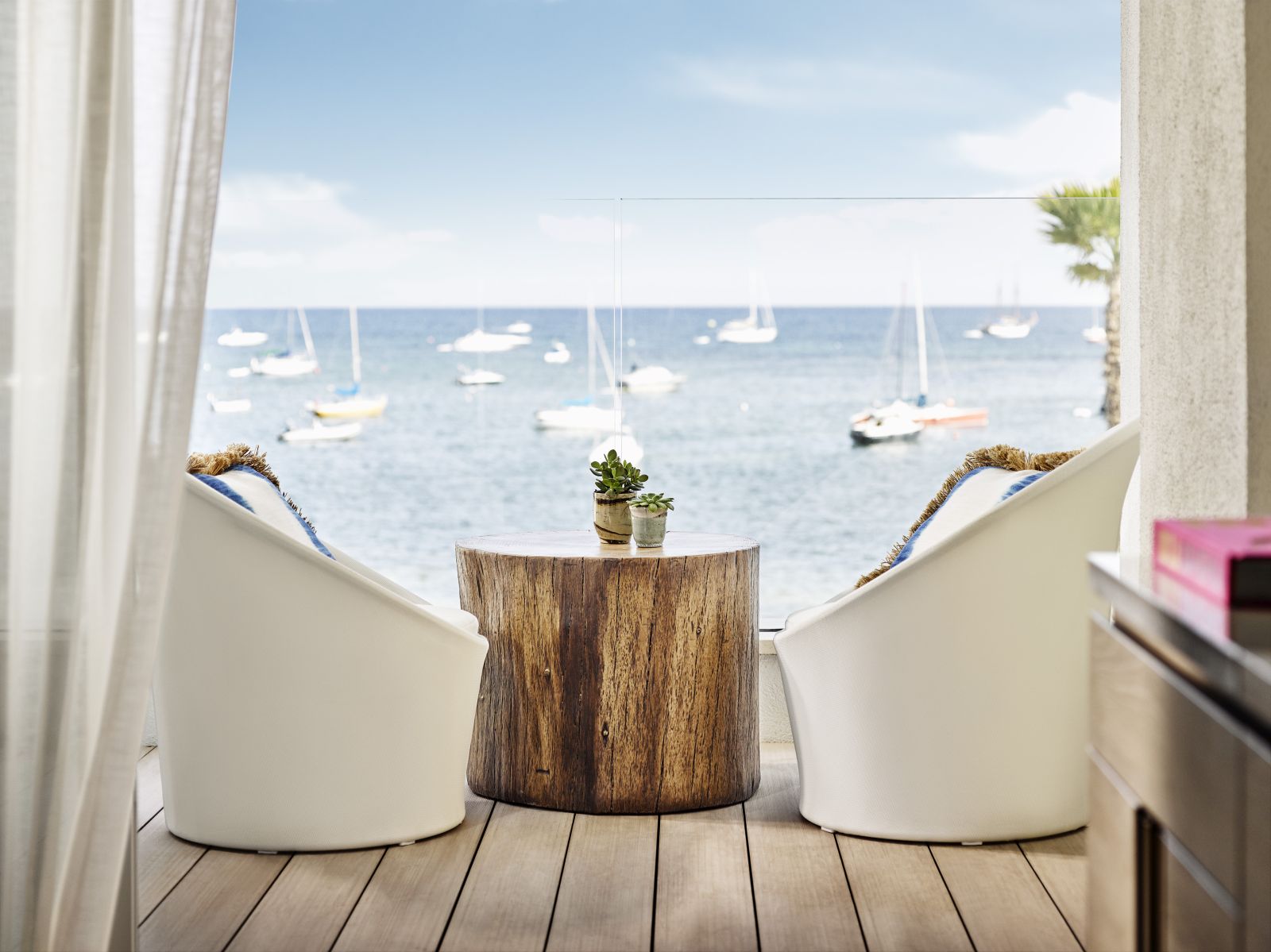 two comfortable chairs on the private balcony of a Deluxe Sea View Room at luxury hotel Nobu Ibiza