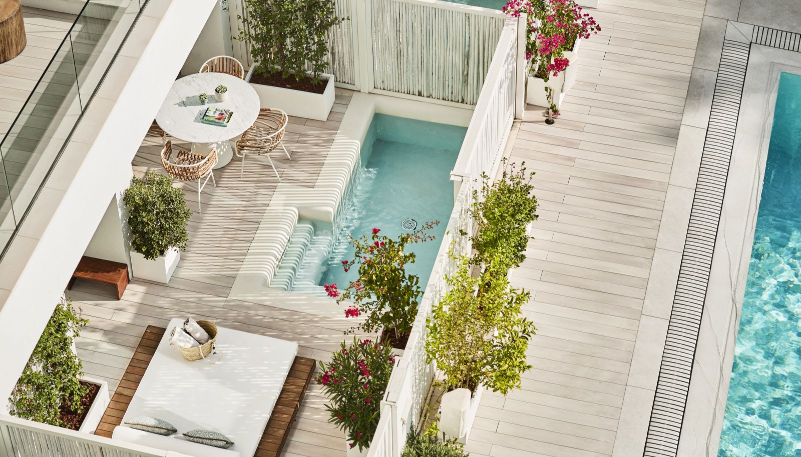 Aerial view of the terrace of a Junior Suite with Plunge Pool, large lounger and private outdoor dining area.