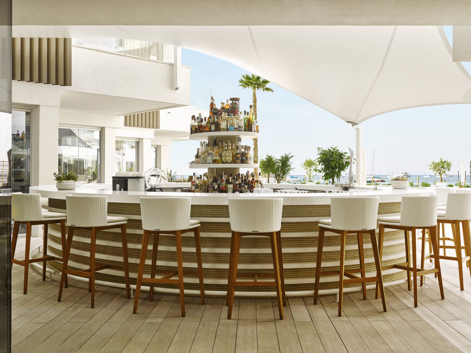 Circular shaded pool bar with bar stools at luxury hotel Nobu Ibiza