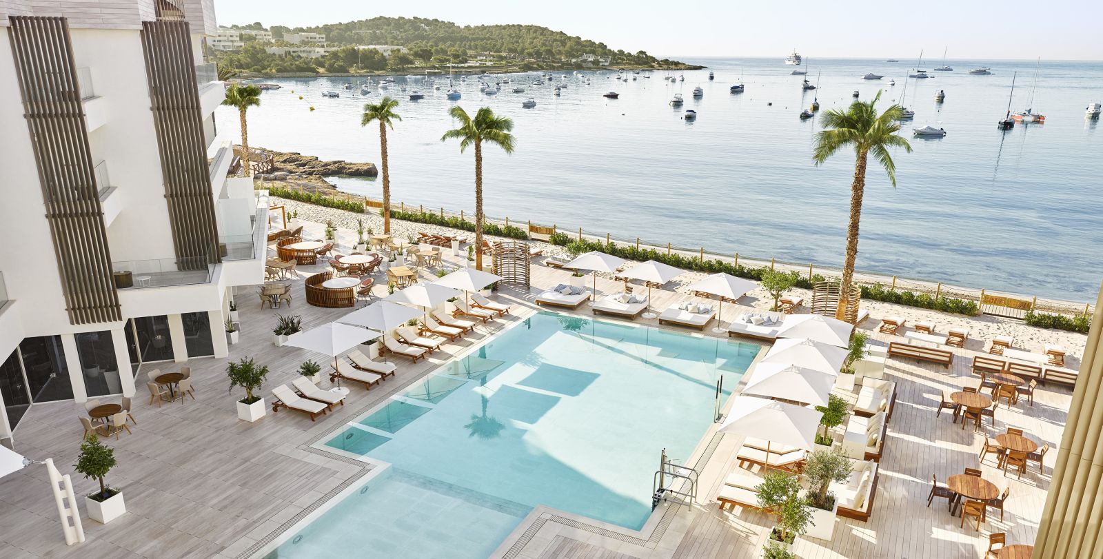 View over the terrace and pool, overlooking the beach and Mediterranean Sea at luxury hotel Nobu Ibiza