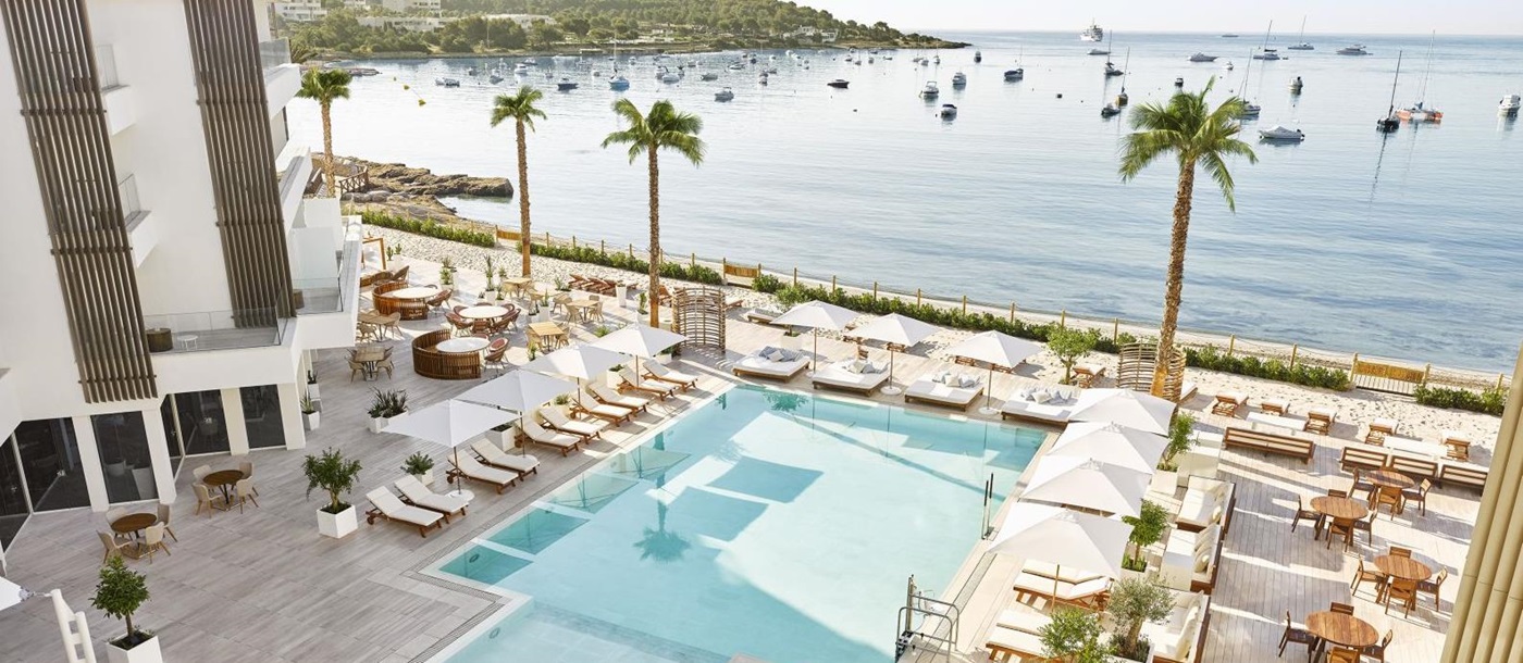 View over the terrace and pool, overlooking the beach and Mediterranean Sea at luxury hotel Nobu Ibiza