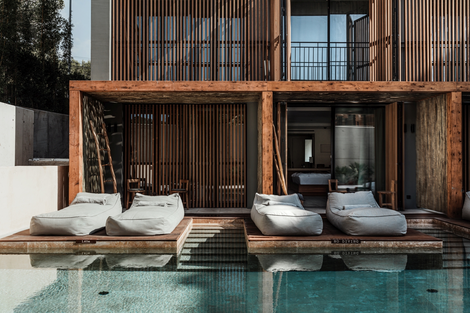 Sun loungers  by the pool at luxury resort OKU Ibiza