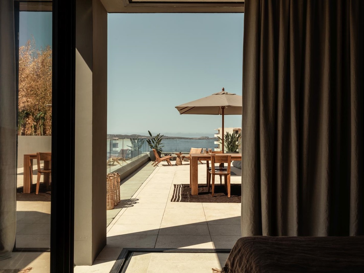View from a bedroom over a private terrace and the Mediterranean Sea at luxury resort OKU Ibiza