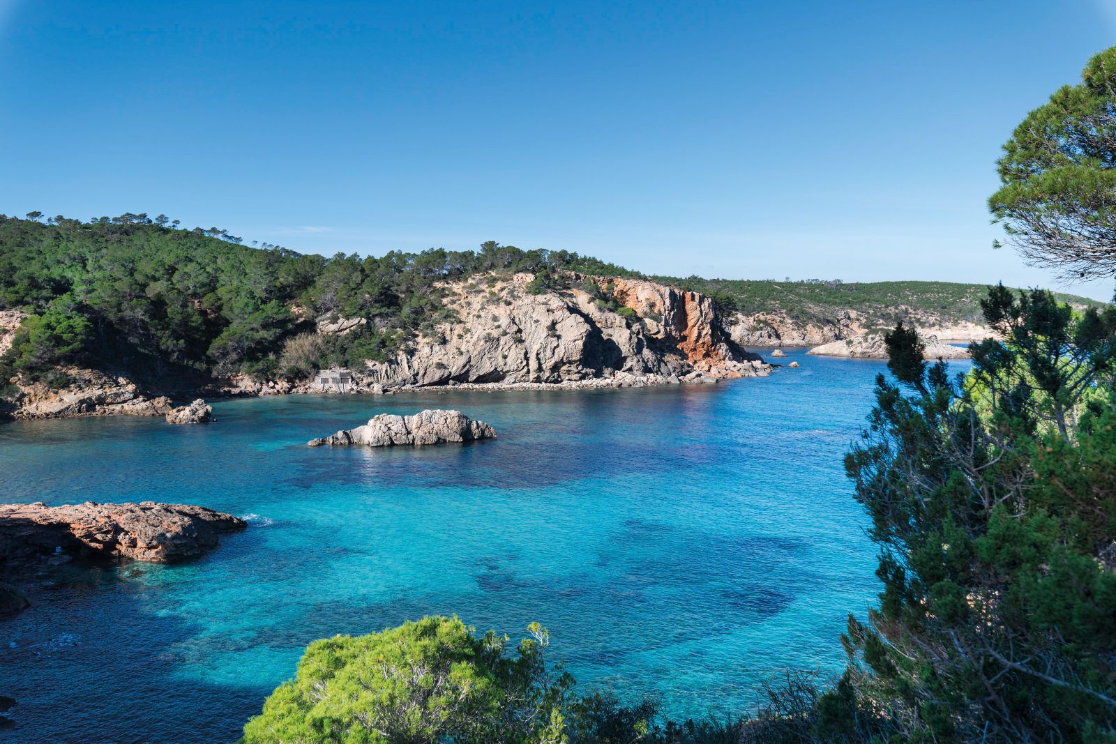 Turquoise coves surrounding the Six Senses Ibiza