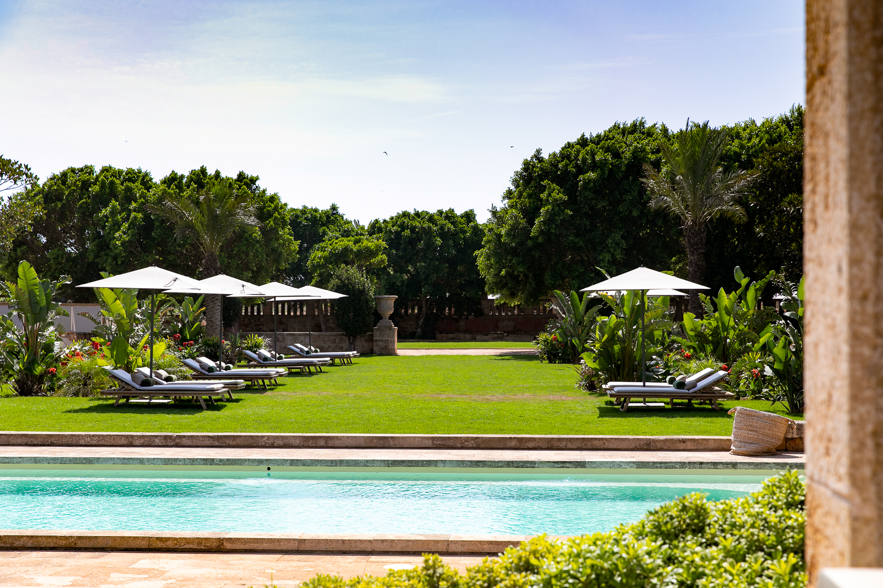 Loungers around the oval swimming pool at Son Vell luxury hotel in Menorca