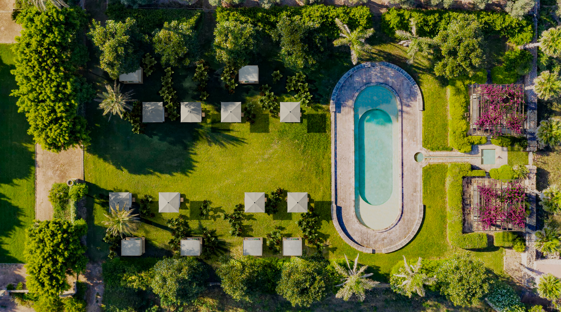 Bird's eye view of the gardens and oval swimming pool at Son Vell luxury hotel in Menorca