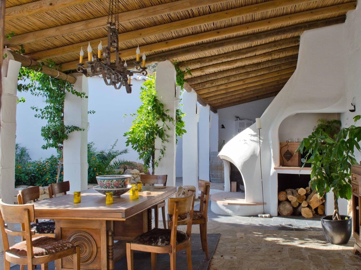 Barbecue area with outdoor dining table at luxury villa El Refugio in Andalucia, Spain