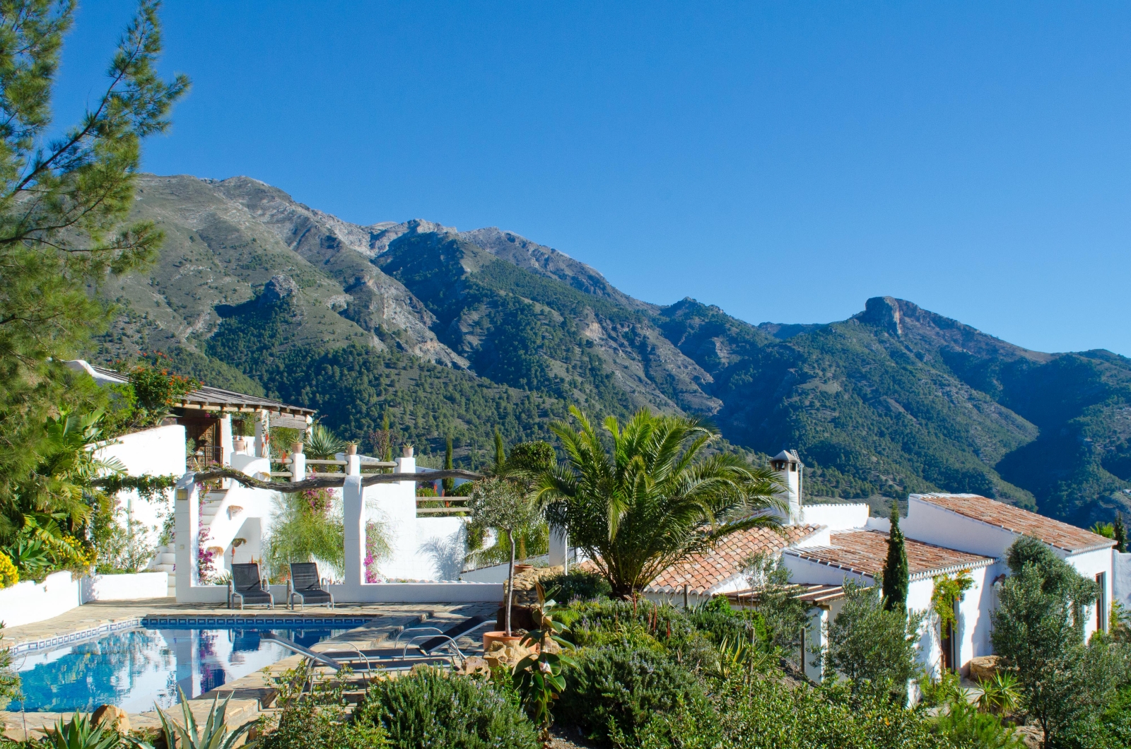 Exterior shot of El Refugio with pool and mountains in the backgroun