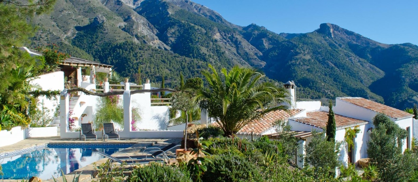 Exterior shot of El Refugio with pool and mountains in the backgroun