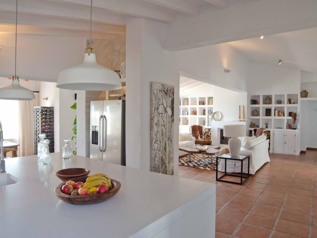 Kitchen island and lounge with decorative shelving at Spanish luxury villa El Refugio