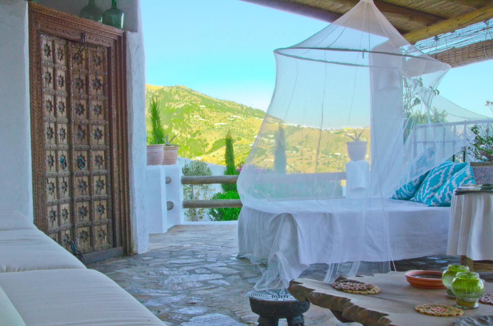 Shaded terrace with a bed-lounger overlooking the Andalucian mountains at El Refugio, luxury villa in Spain